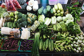 Fresh green vegetables display at a farmers market stall