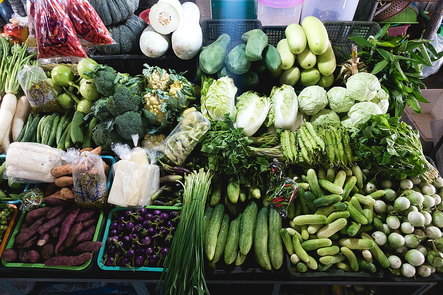 Fresh green vegetables display at a farmers market stall