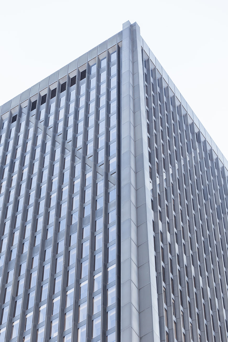 Low angle view of modern glass office building facade