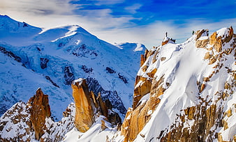 Mountaineers on Snowy Mountain Ridge with Blue Sky