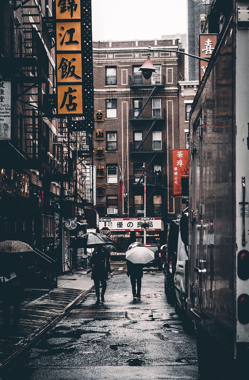Rainy Chinatown Street with Umbrellas and Asian Signs