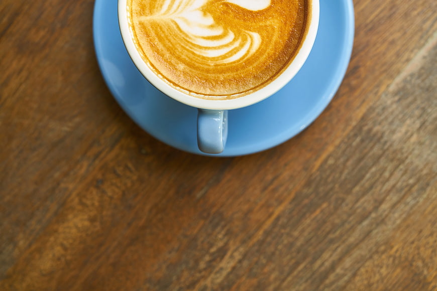 Top View Cappuccino with Latte Art on Wooden Table