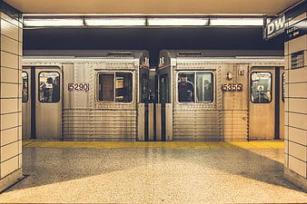 Two subway trains coupled at a station platform