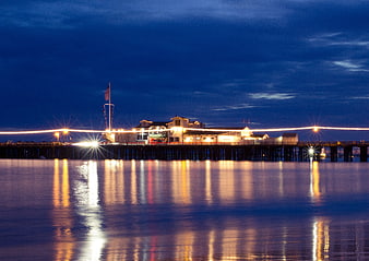 Long Exposure Night View of Illuminated Ocean Pier