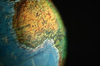 Close-up of a globe showing West Africa with shallow depth of field