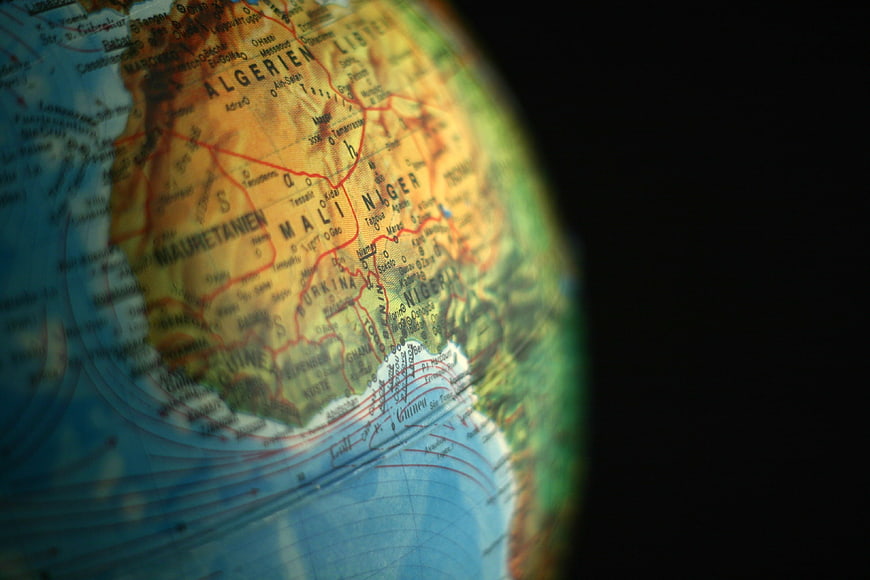 Close-up of a globe showing West Africa with shallow depth of field