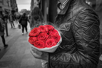 Man Holding Red Roses On City Street