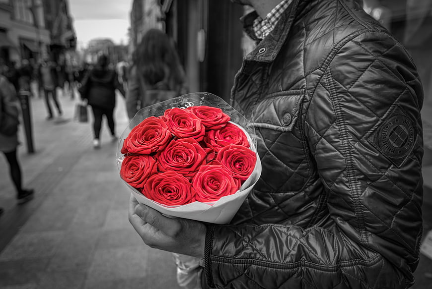 Man Holding Red Roses On City Street