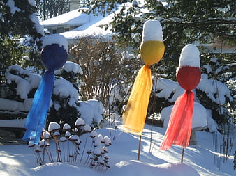 Colorful Balloon Garden Stakes in Snowy Winter Yard