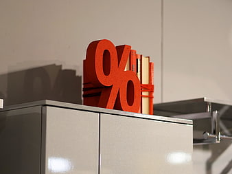 Red Percent Sign Sculpture On Modern Office Cabinet