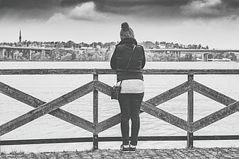 Woman in Beanie Looking at River Cityscape Black and White