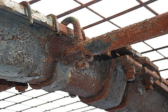 Close-up of rusty industrial metal beams and bolts
