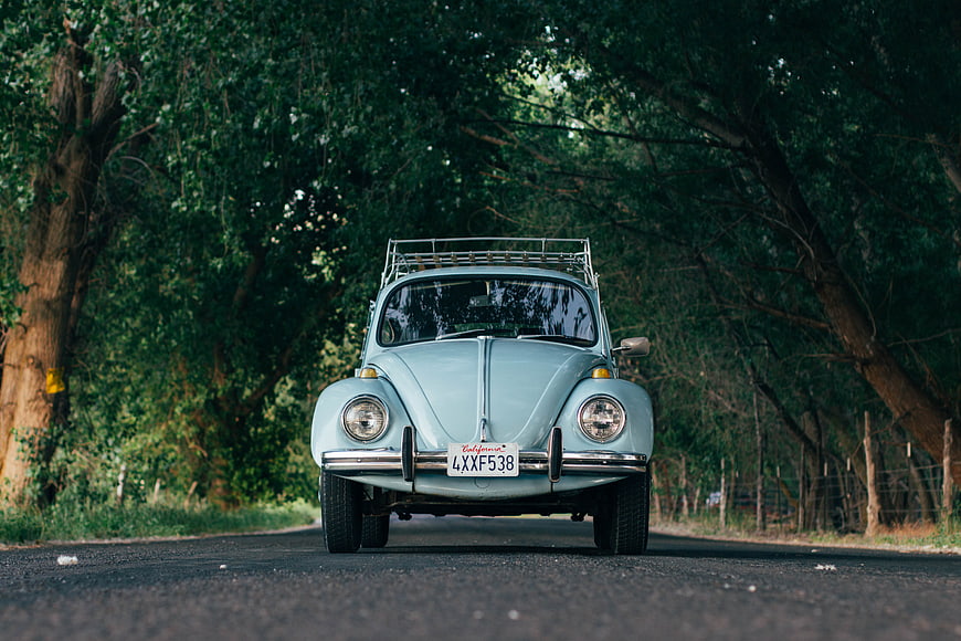 Vintage Light Blue Volkswagen Beetle on Rural Road