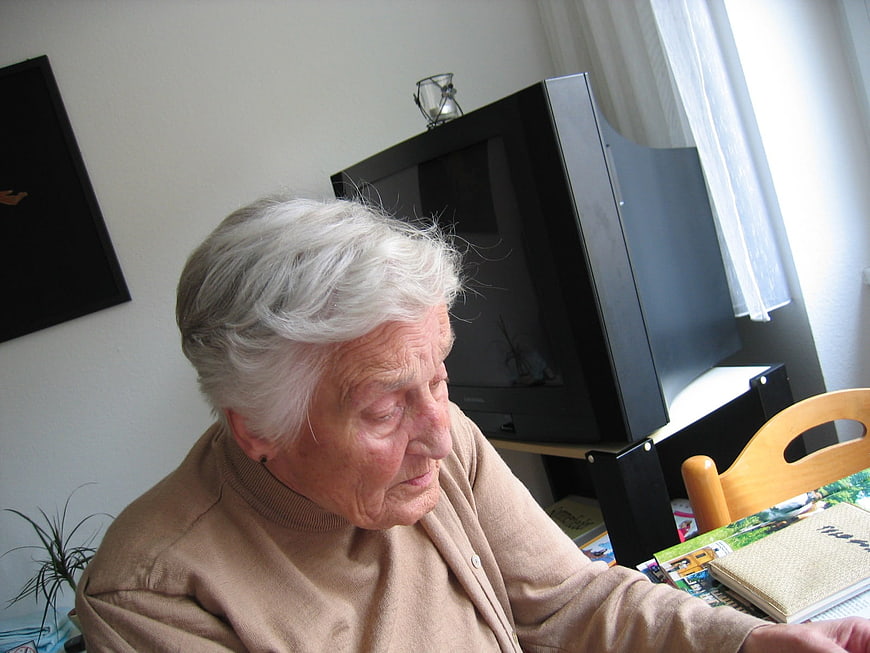 Senior woman with dementia sitting in a living room