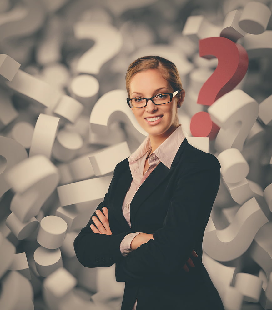 Confident businesswoman with arms crossed against background of 3D question marks