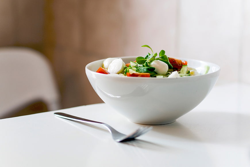 Fresh Caprese Salad in White Bowl with Fork