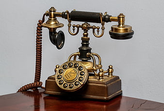 Vintage Brass Rotary Telephone On Wooden Table
