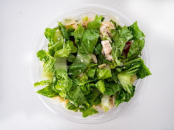 Top View of Chicken Caesar Salad in Plastic Container