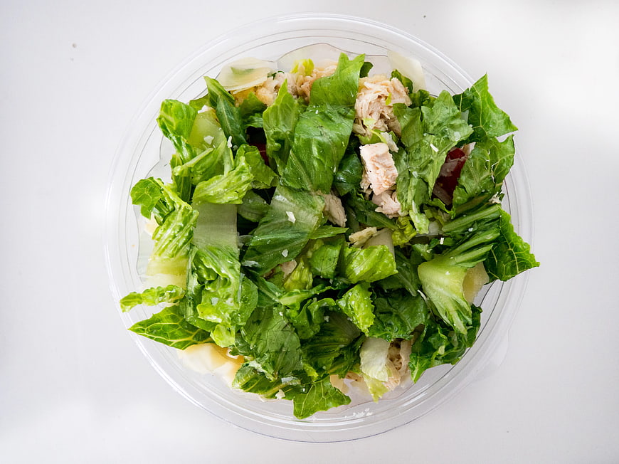 Top View of Chicken Caesar Salad in Plastic Container