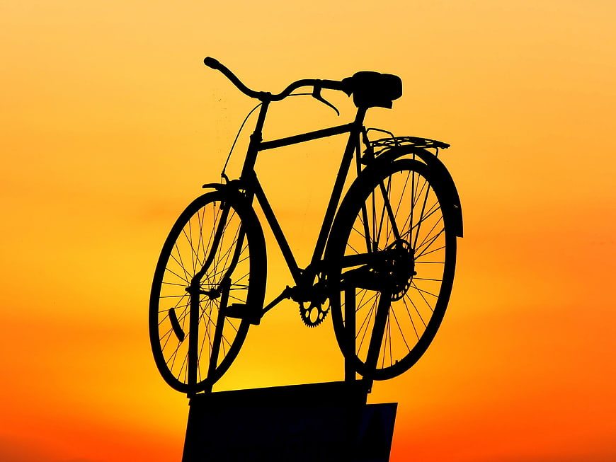 Bicycle Silhouette Against Vibrant Orange Sunset Sky