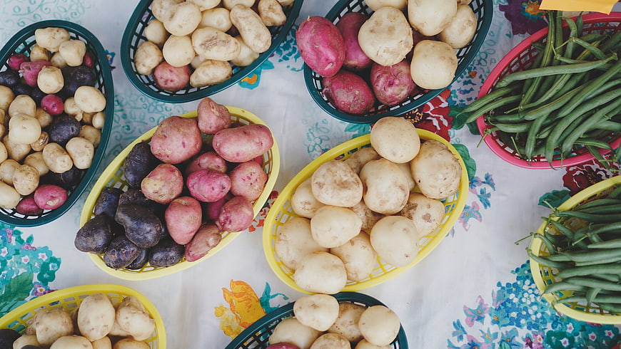 Top View of Colorful Potatoes and Green Beans in Baskets