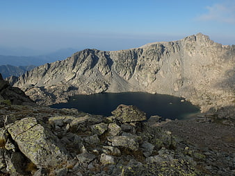 Panoramic View of Alpine Lake Surrounded by Rocky Mountains