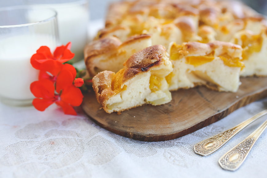 Homemade fruit pie with milk and red flowers