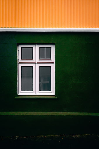 Minimalist Green Wall with White Window and Orange Roof