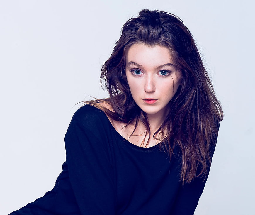 Portrait of Young Woman with Blue Eyes and Messy Hair
