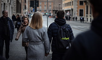 Couple Walking Hand in Hand on City Street