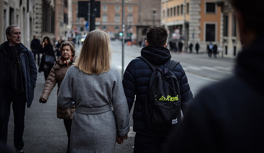 Couple Walking Hand in Hand on City Street
