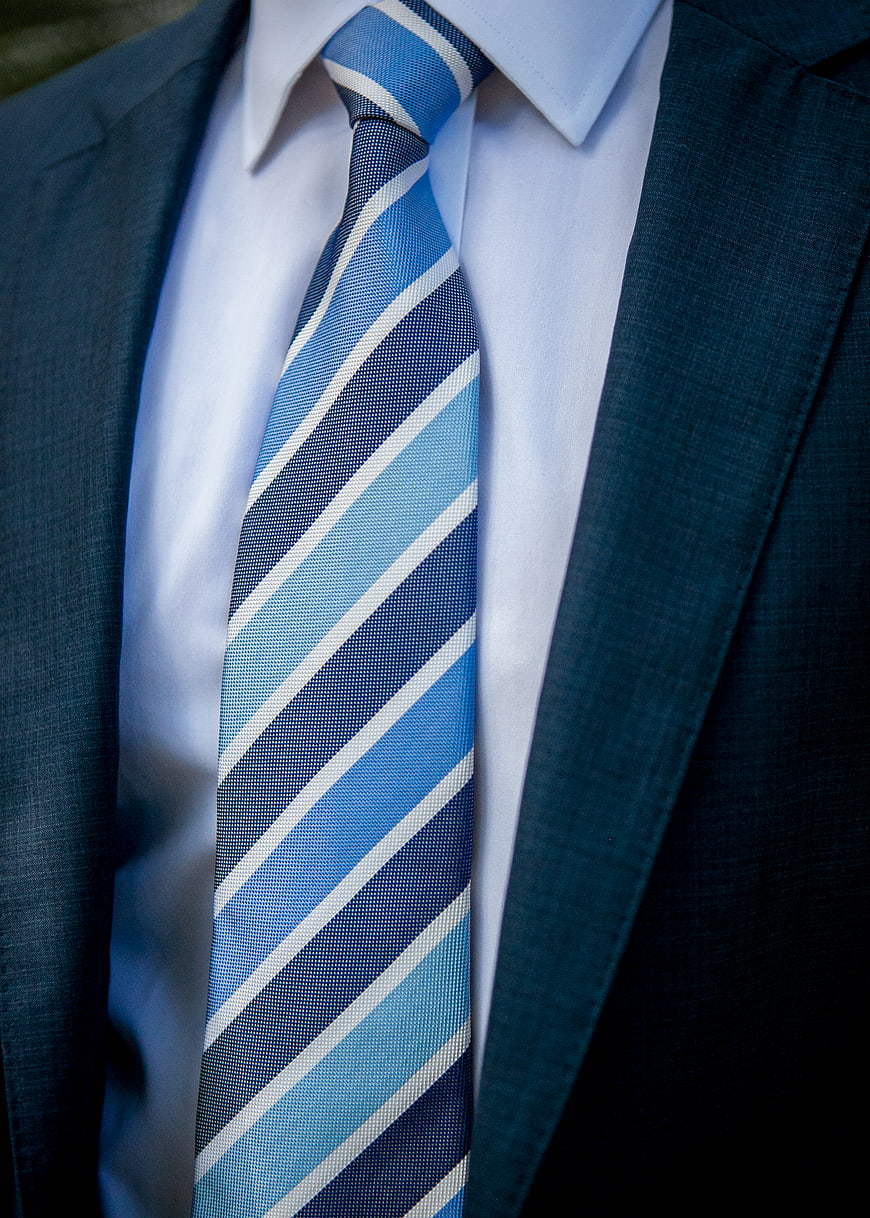 Close-up of blue striped tie and suit jacket