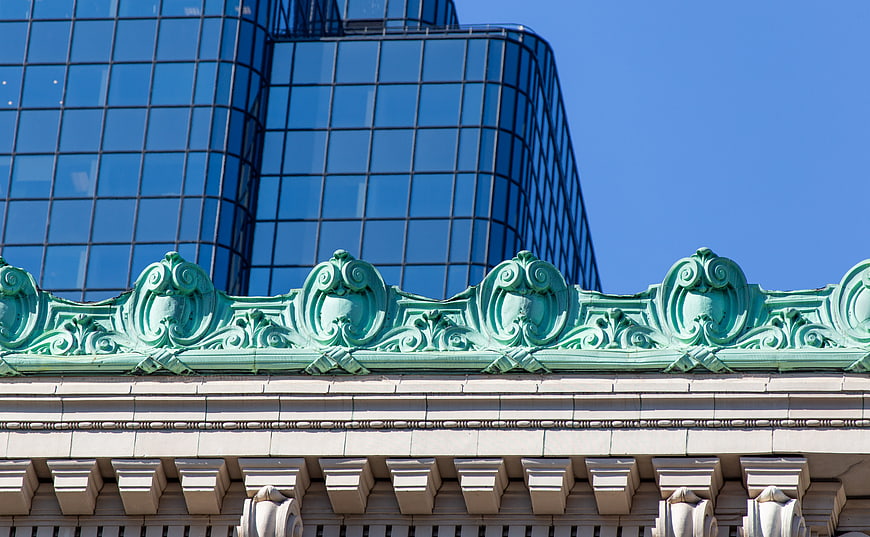 Ornate Green Copper Roof Detail Against Modern Glass Skyscraper