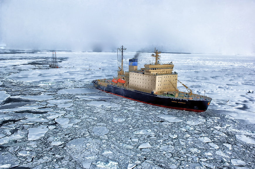 Icebreaker ship navigating through frozen arctic waters