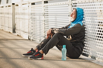 Senior man resting after outdoor workout on bridge