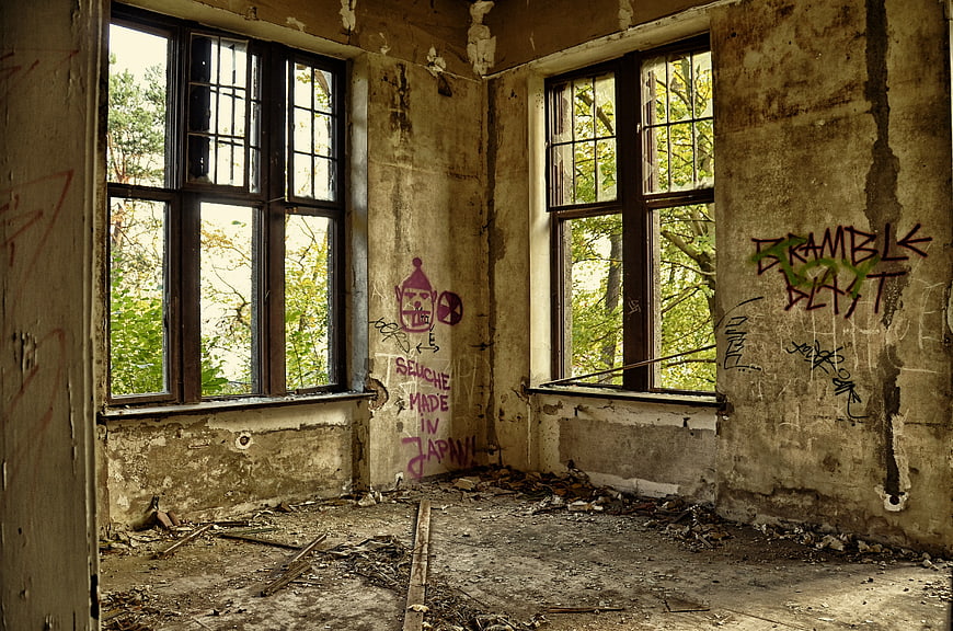 Abandoned Room Interior With Graffiti and Peeling Walls