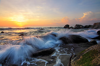 Long Exposure Sunset Waves Crashing on Rocky Coastline