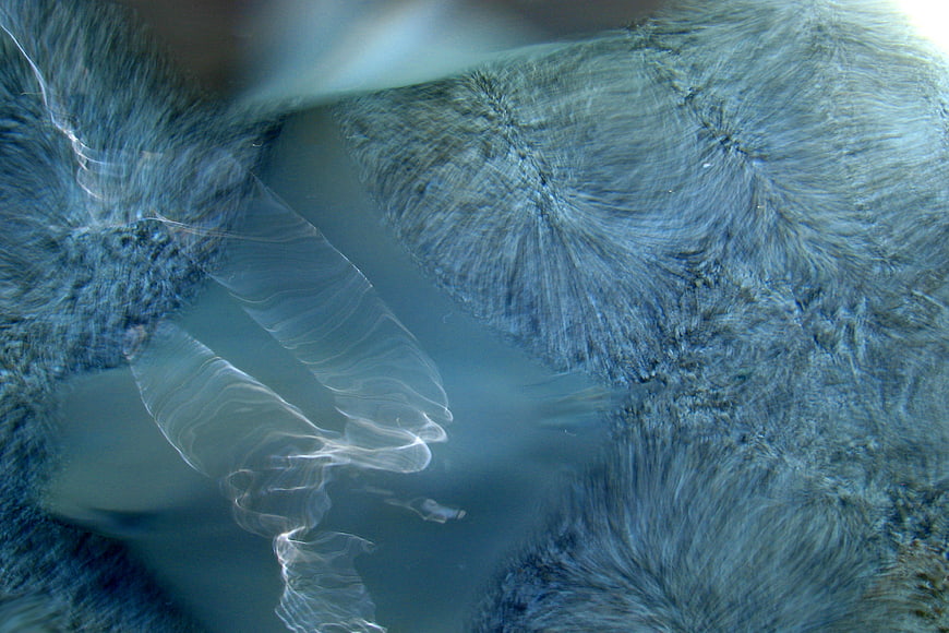 Abstract blue crystalline water texture with flowing patterns