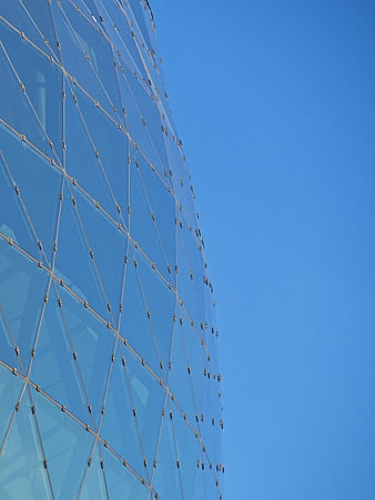 Modern Glass Building Facade Against Blue Sky