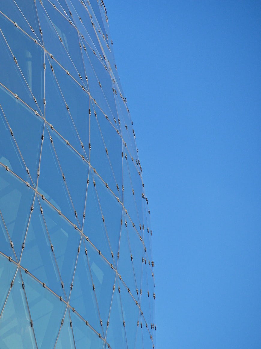 Modern Glass Building Facade Against Blue Sky