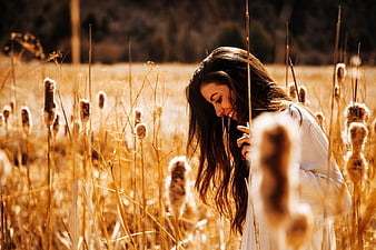 Happy Woman Laughing in Golden Field of Dried Reeds
