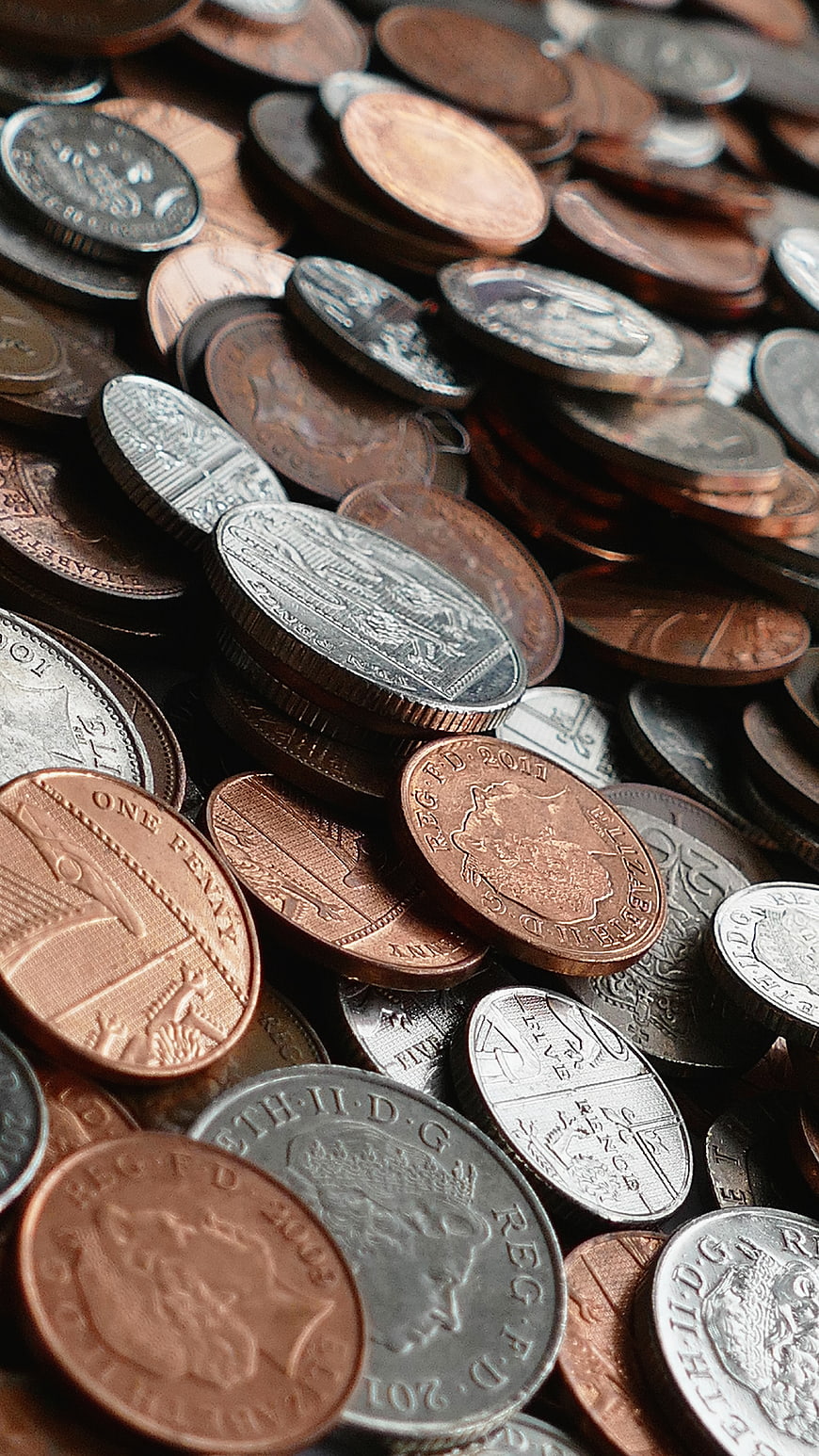 Close-up of mixed British coins and currency