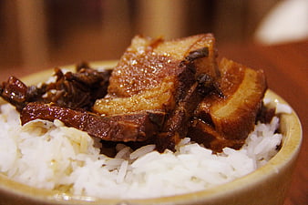 Close-up of braised pork belly with rice in a bowl