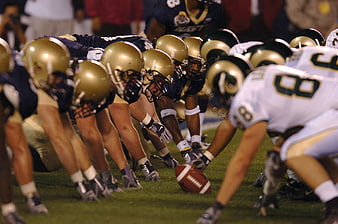 American football teams lined up at scrimmage on field
