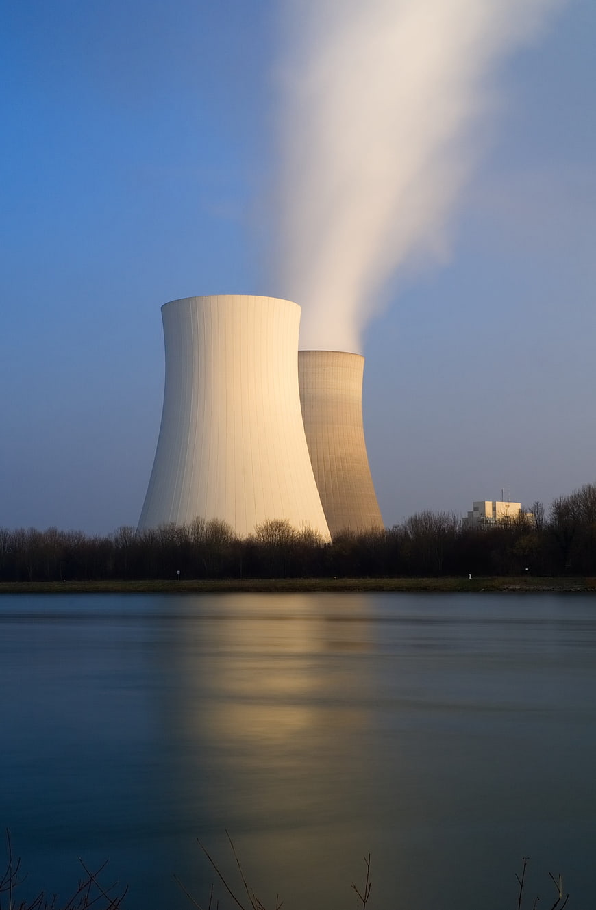 Nuclear Power Plant Cooling Towers Reflected in River at Dusk