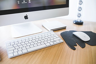 Minimalist Apple iMac workspace with keyboard and mouse