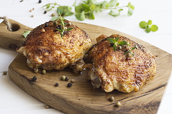 Roasted Chicken Thighs With Herbs On Wooden Board
