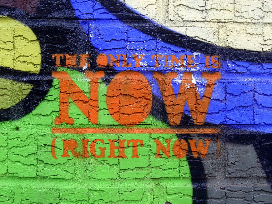 Colorful Graffiti Wall with Motivational Quote The Only Time Is Now