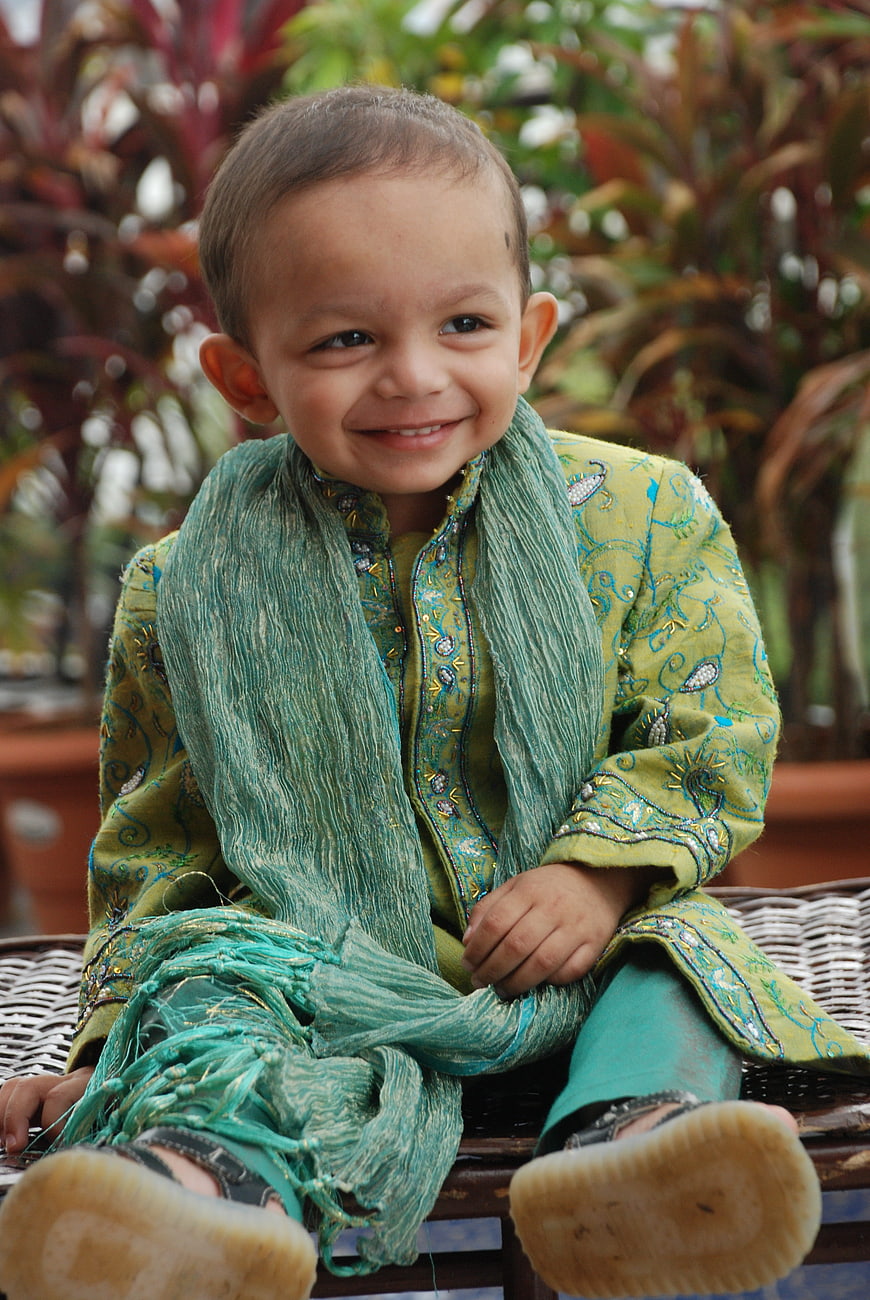 Smiling Indian Boy in Traditional Green Embroidered Outfit
