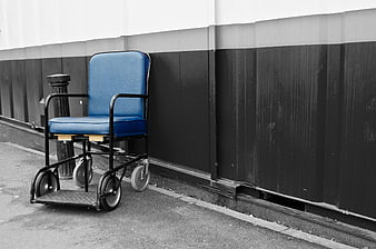 Blue wheelchair against black and white wall